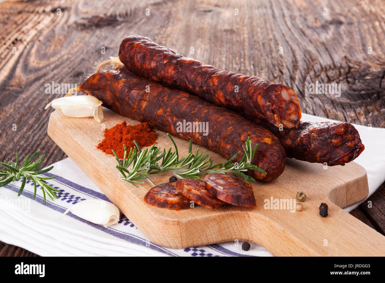 Traditional sausage with pepper, garlic, thyme and rosemary on wooden ...